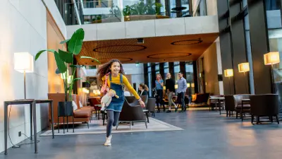 Mother and daughter walking through an office building