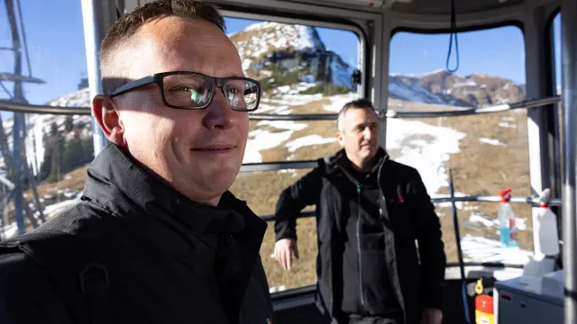Michel Huger and Roland Simion riding the gondola lift up to the summit