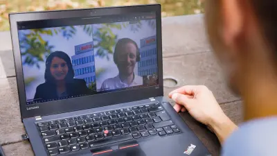 Bosch associates in a video call, looking at notebook