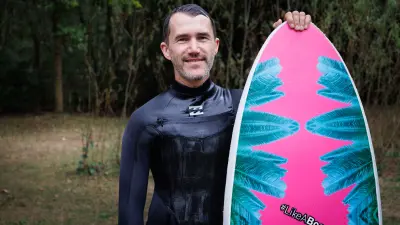 Bosch associate Kajetan Fritz with surfboard and wetsuit