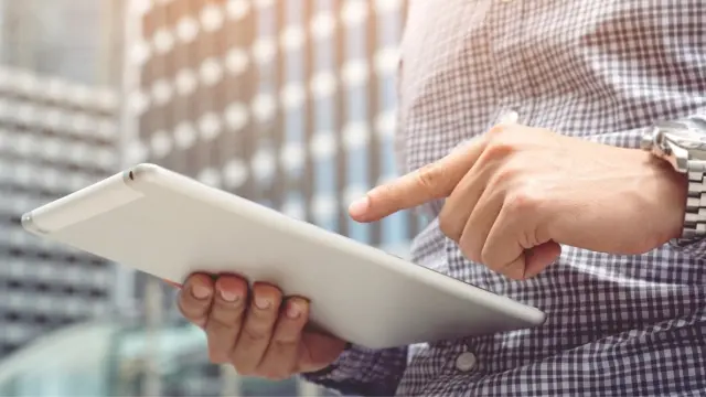 Man typing on tablet