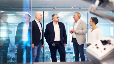 Babor and Bosch representatives in front of the transparent production facility, Babor Beauty Group Eschweiler