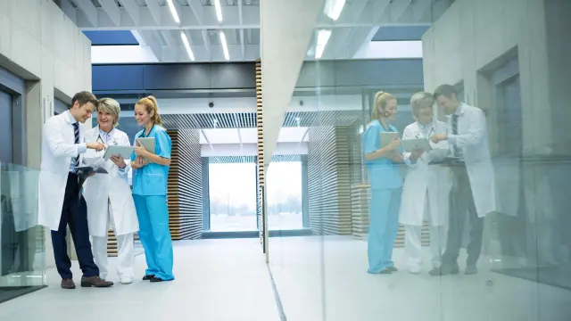 Two doctors and a nurse talking in the hall.