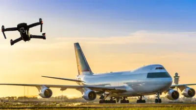 Drohne fliegt neben Flugzeug, das auf der Landebahn steht.