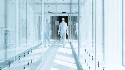 Employee in protective clothing walks through the clean room