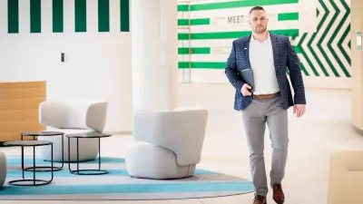 Marius Kaiser walks through the Service & Supply Chain Campus building in Stuttgart-Feuerbach