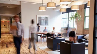 Several colleagues work in an open workingspace