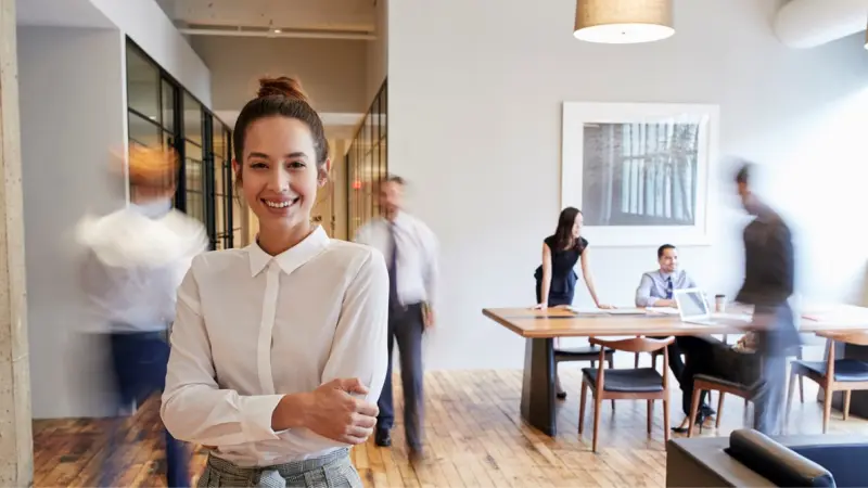 Woman standing in the office and smiling