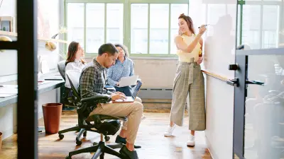 A young employee meeting with four colleagues
