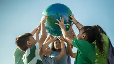 Pupils hold up a globe