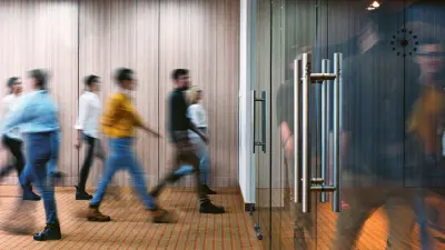 Group of people in the corridor of a public building, glass door, out of focus