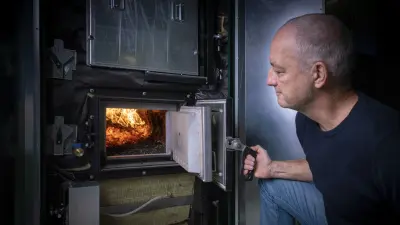 Wood chip plant at Sozialwerk Am Bruckwald, interior, view into the combustion chamber with Peter Buehler from Bosch