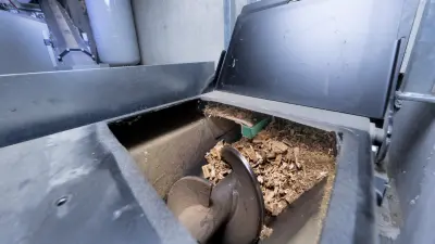 Wood chip plant at Sozialwerk Breisgau, interior, screw conveyor transports wood chips