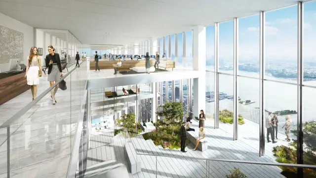 Mehrere Menschen sitzen, stehen und gehen im Atrium des Wolkenkratzers