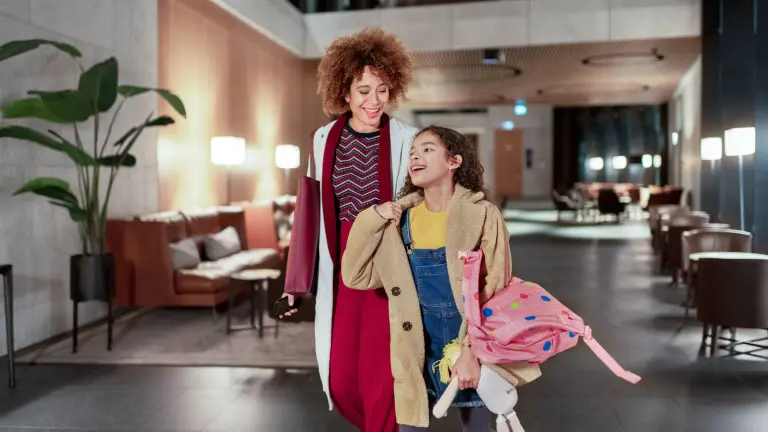 Mother and daughter in lobby of modern office building