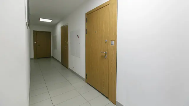 Corridor in apartment building with closed doors