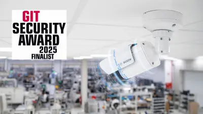 Bosch AVIOTEC 8000i IR camera in white housing installed at ceiling monitoring industrial manufacturing hall for electronic components