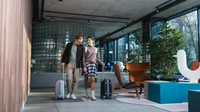 A couple strolling through a hotel lobby.