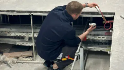 Bosch employee installing fire detector