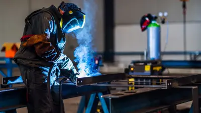 Man soldering in an industrial factory
