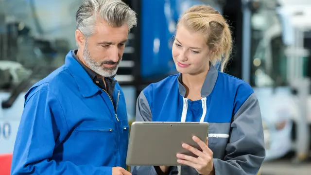 Due addetti alla manutenzione con un tablet