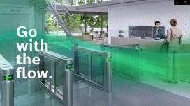 The reception area of an office protected by access control using turnstiles, with the slogan 'Go with the flow'.